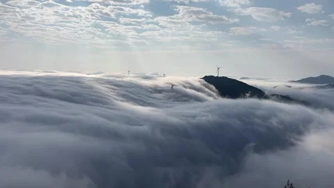 Time-lapse of rolling sea of clouds and wind turbines on mountain ridge Stock Footage 330119536