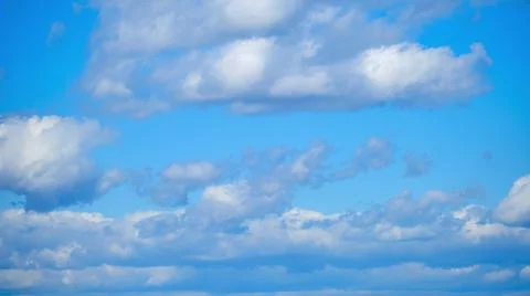 Time lapse with rotating clouds in the blue sky floating parallel to the view Stock Photos