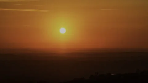 Time Lapse of Ruby Red Sun Sets into Twilight with City Lights Stock Footage 278660971