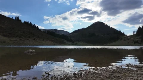 A time lapse of running clouds over a mountain lake. Stock Footage 317633801