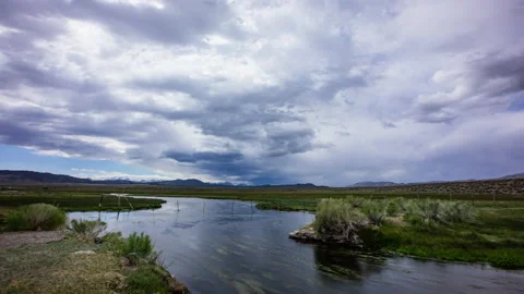 Time Lapse - Running stream in the meadow with cloudy sky Stock Footage 156593158