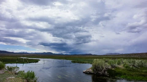 Time Lapse - Running stream in the meadow with cloudy sky Stock Footage 161119806