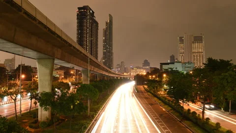 Time-lapse of Rush hour traffic on highway and sky train at dusk Stock Footage 144136322
