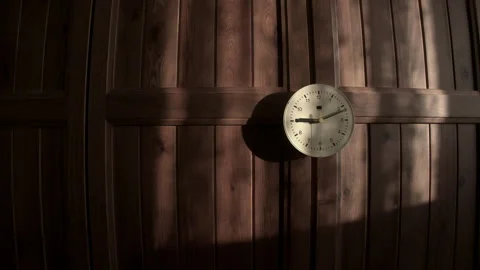 Time lapse of a Rustic Wall Clock on Warm Wooden Paneling in a Sunlit   Room Video stock 320288365