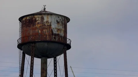 Time lapse of Rusty Water Tower with Blue Sky Close Up Stock Footage 117705128