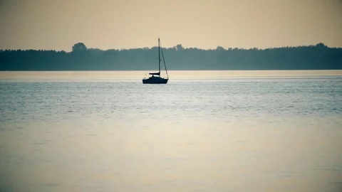 Time lapse of sail boat far off on lake or river Stock Footage 73829586