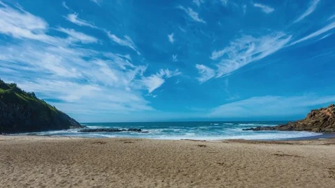 Time lapse of sandy beach with waves and clouds Stock Footage 73568151