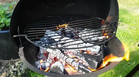 Time lapse of sausages getting grilled, on a wooden heated barbeque, on a war Stock Footage 64028657