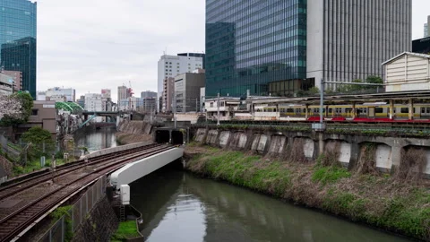 Time lapse scene of moving train passes through the Hijiri-bashi Bridge and.. Stock Footage 274868863