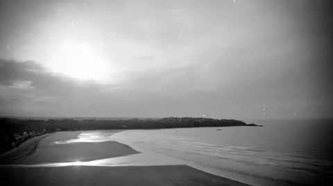 Time-lapse scenery of a bay in evening during the tide - old monochrome movie Stock Footage 49386241