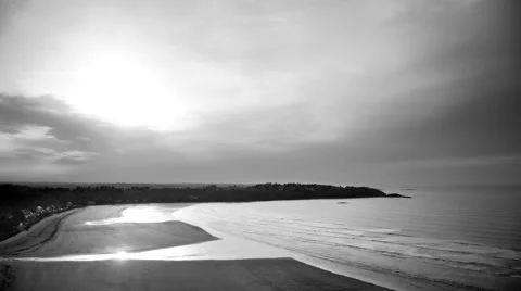 Time-lapse scenery of a bay in evening during the tide in black and white Stock Footage 49386853
