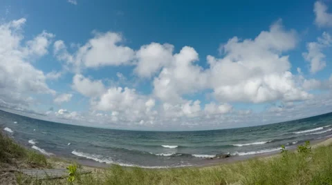 Time Lapse Scenic Clouds on Blue Sky Over Water and Beach Stock Footage 55744040