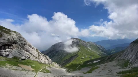 Time lapse scenic view of clouds moving over majestic mountains at Alpnachstad Stock Footage 136573533