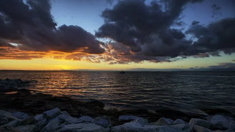 Time Lapse Scenic View Of Clouds Moving Over Sea During Sunset - British Stock Footage 160319508