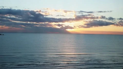 Time-lapse of sea sunrise. Sun is appearing from the clouds Stock Footage 201229662