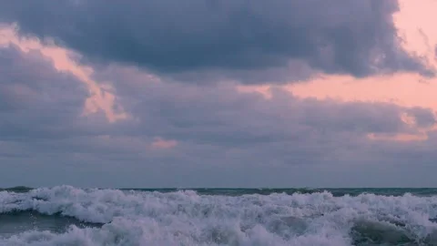 Time Lapse Sea Waves Orange Pink Sky Purple Black Gray Cumulus Rain Clouds in Su Stock Footage 299235319