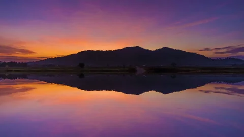 Time Lapse Of Semanggol Hill During Beautiful Sunrise With Reflection.HD Stock Footage 133788059