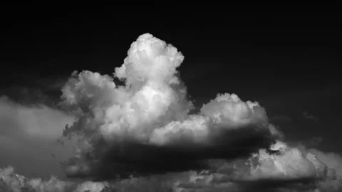 Time-lapse of separate white clouds on a black background shows real clouds.. Stock Footage 311082848