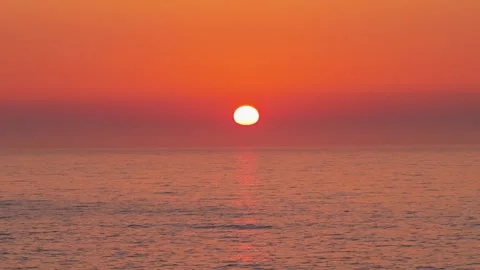 A time-lapse sequence showing the sun setting over the calm waters of the Stock Footage 346719608