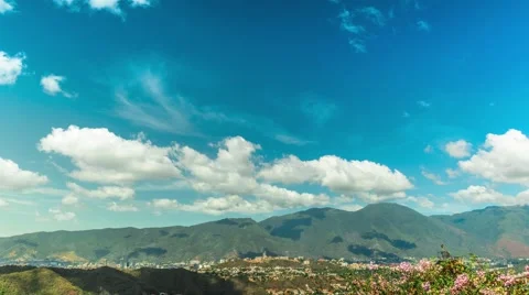 Time lapse sequence of tropical clouds moving along a city Stock Footage 58660537