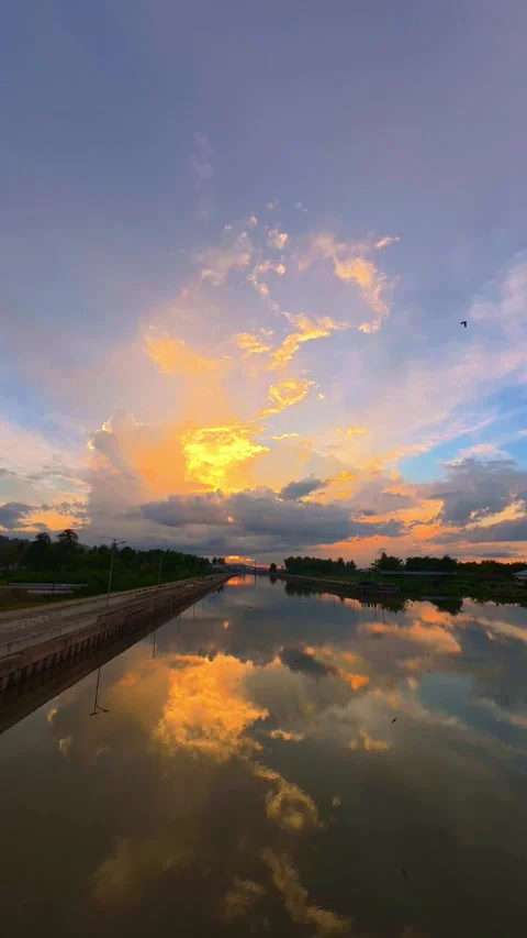 Time-lapse of Serene Sunset Reflected on Calm Water Stock Footage 308395875