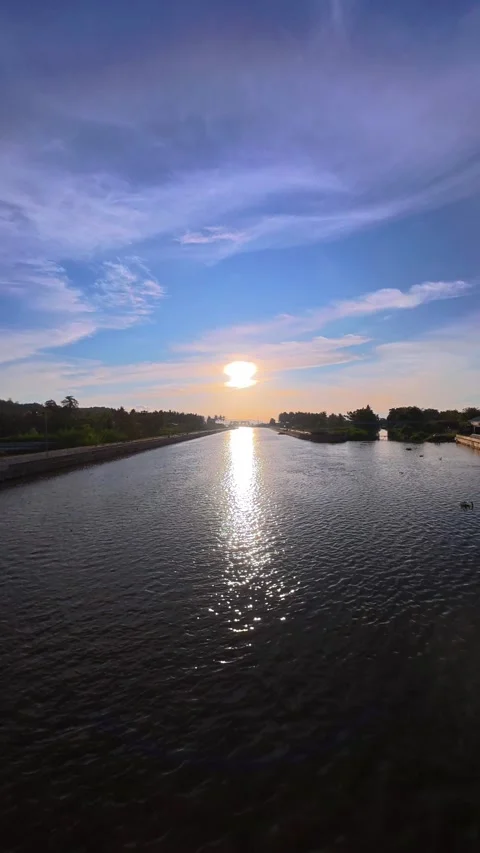 Time-lapse of Serene Sunset Reflected on Calm Water Stock Footage 308399768