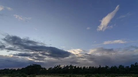 Time lapse with the setting sun behind the moving clouds, Netherlands Stock Footage 95855266