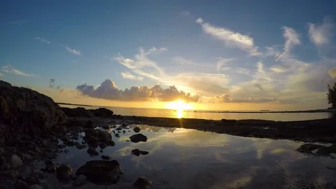 Time lapse of setting sun over rock pools at 4th Hole Beach, Bahamas 4K Stock Footage 94909976