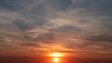 Time lapse. The setting sun paints the clouds in the sky Stock Footage 254240438
