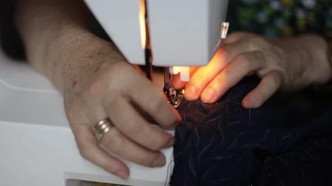 Time lapse: sewing machine on clothes and material. Tailor at work. Close up Video stock 135130314