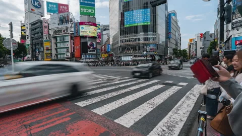 Time lapse at Shibuya intersection, crowded and traffic crossing the intersectio Stock Footage 277529480