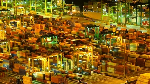 Time-lapse of shipping cargo being moved at night multiple vehicles and 库存影片 104819427
