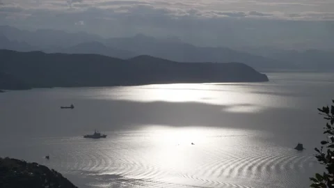 Time-lapse of ships passing and sunny spots dancing on the sea Stock Footage 243187927