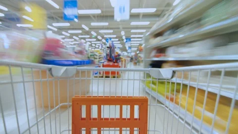 Time Lapse of the Shopping Cart Moving Between Various Aisles in Supermarket Stock Footage