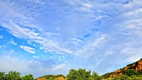 Time-lapse shot of blue clear sky with white clouds floating Stock Footage 152497139