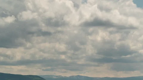 A time-lapse shot of a bright blue sky covered with large fluffy white cumulus Stock Footage 317392000
