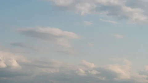 A time-lapse shot of a bright blue sky covered with large fluffy white cumulus Stock Footage 317614651