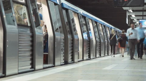 Time Lapse shot of a busy metro station with people boarding trains and leaving  Stock Footage