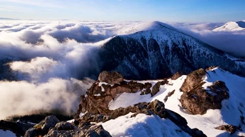 Time lapse shot of clouds below mountain peak in winter shortly after sunrise Stock-Footage 268602549