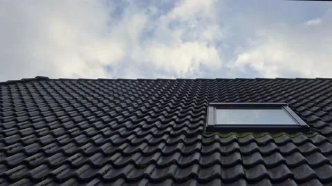 Time-lapse shot of clouds reflected in window of residential house roof with  Stock Footage 164335052