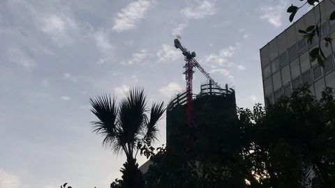 Time Lapse Shot of a Crane Above a Skyscraper Construction Site in Cyprus Stock Footage 101478636