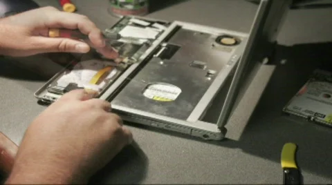 A time lapse shot of hands putting together a laptop computer. Stock Footage 556434