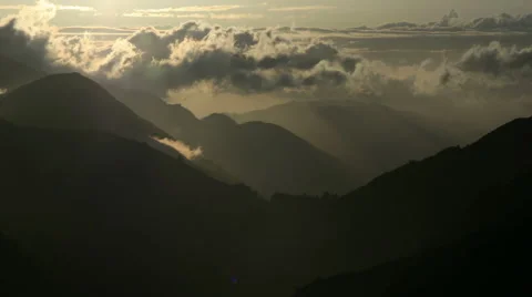 Time Lapse shot of Haze filled valley with mountains and clouds Stock Footage 48681774