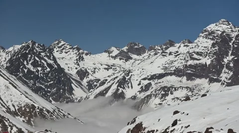 Time lapse shot of low clouds moving through the Andes mountains in Chile Video stock 63278810