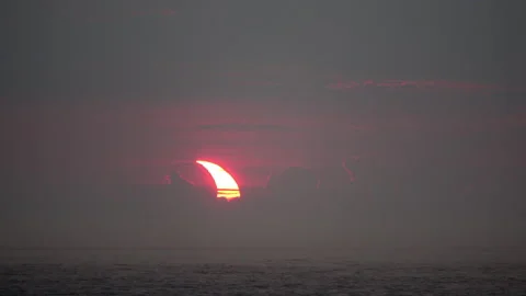 Time-lapse shot of partial solar eclipse at sunrise showing Stock Footage 155669554