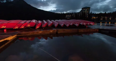 Time Lapse Shot Of Red Canoe Arranged On Wooden Pier Over Lake By Snowy Stock Footage 160318520