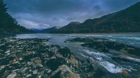 Time lapse shot of a river near mountain forest. Huge rocks and fast clouds Stock Footage 115083243