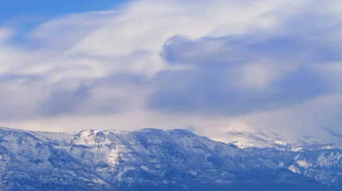 Time-lapse shot of snow-covered mountain peaks in Utah Stock Footage 52327759