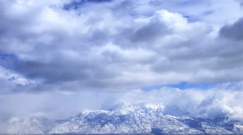 Time-lapse shot of snow-covered mountain tops in Utah Stock Footage 52328250