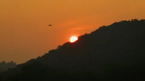 A time lapse shot of a sun going down behind the hill Stock Footage 282442015